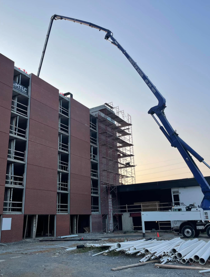 Concrete pump truck placing a structural deck on a Middle Tennessee commercial building